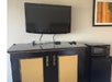 Flat-screen TV, microwave and refrigerator in a non-smoking guest room. 