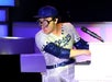 Performer in a baseball costume playing the piano in the British Invasion Show at the Americana Theatre in Branson Missouri.