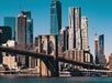 View of the Brooklyn Bridge with the New York City skyline in the background on a clear day.
