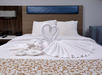 A neatly made bed inside a guest room