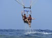 A couple soaring through the sky, enjoying a thrilling parasailing adventure.







