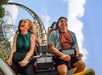 Two riders smiling on Pantheon's multi-launch roller coaster.