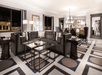 Spacious modern living room with a large gray sectional sofa, geometric patterned carpet, glass coffee tables, and elegant lighting, featuring large windows and framed artwork.