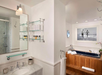 Modern bathroom with a tub and stylish sink.