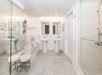 Spacious bath area featuring a double vanity, shower, and tub.