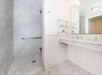 Accessible bathroom featuring a roll-in shower and sink.