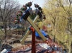 Lumberjack ride featuring two swinging axe pendulums propelling guests in a circular motion around 360-degree loops.
