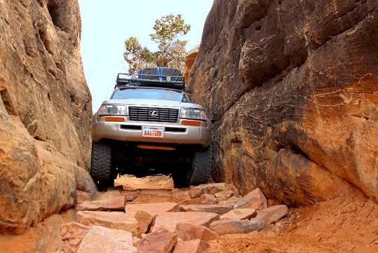 NAVTEC 4x4 Landcruiser passing through the famous Elephant Hill with supllies strapped to the top and a clear sky behind it.