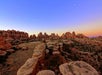 Wide shot of the rock formations at the Needles District in the Canyonlands a dusk with some of an orange sunset still visible.