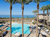 Outdoor pool with sun loungers.