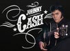 A man dressed in black holds an acoustic guitar next to stylized text reading "Johnny Cash" on a dark background.