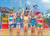 Kids splashing through colorful Buccaneer Cove water play zone.