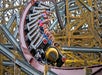 The Steel Vengeance roller coaster full of people people laughing and screaming while it goes down hill.