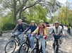 A group of people riding bicycles on a street.