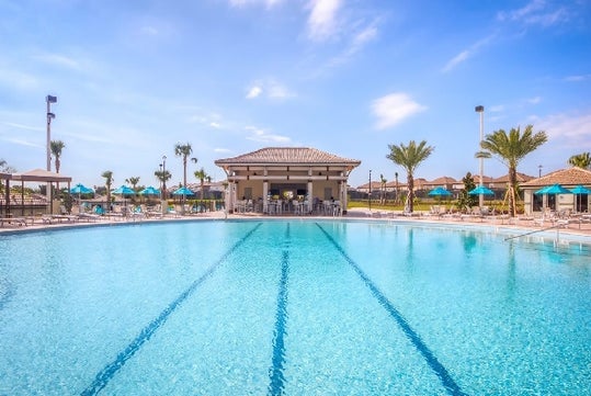 Championsgate Resort by Global Vacation Rentals' outdoor clubhouse pool and cabanas.