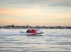 Speedboat gliding past the Charleston shoreline.