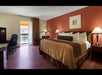 One king bed and a work desk inside a guest room.