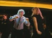 A man and woman dancing on the Chicago Premier Dinner Cruise on Lake Michigan where DJ sets the mood on the climate-controlled interior decks.