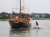 A small pirate ship called the Sea Gypsy with kids and fighting Pirate Pete who is on a smaller boat by shooting water at him.