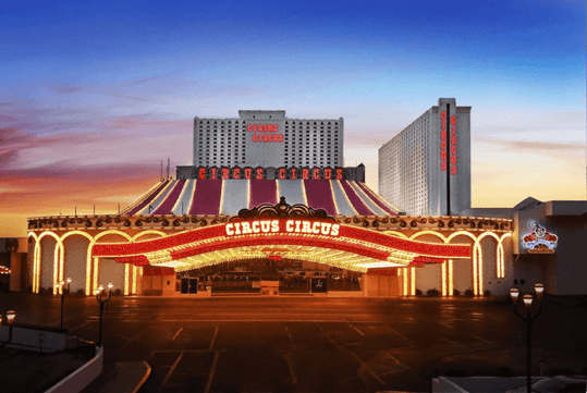 Exterior view of the Circus Circus hotel and casino in Las Vegas, Nevada, with its illuminated entrance at sunset.