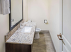 Guest bathroom features a clean and functional sink and toilet for your convenience.