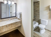 The bathroom features a clean and functional sink and toilet for your convenience.