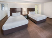 Guest room features two comfortable queen beds, perfect for a restful stay.