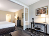 The room features two queen beds, a work desk, and a TV—perfect for both relaxation and productivity.