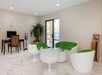 A business center with a desktop and chair, and retro-futuristic and playful designed seating area.