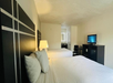 Relax and unwind with two cozy queen beds, a work desk, and a TV.