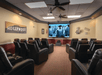 Theater room complete with a wide-screen TV and leather reclining chairs.