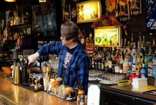 Bartender preparing craft cocktails at a South Lake Union restaurant during the Seattle happy hour tour.