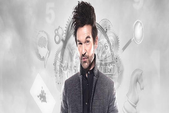 A person with styled hair and a smirk stands in front of a digital background featuring numbers, gears, a chess piece, and a playing card.