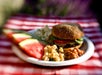 A plated meal of a hamburger, beans, pasts salad, and watermelon for lunch on the Colorado River Full-Day Rafting Adventure in Moab Utah.
