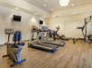 A fitness center with several pieces of cardio equipment and a few weight machines at the Comfort Inn Denver Central.