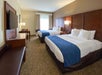 Guest room with 2 Queen beds, flat-screen TV, and a work desk and chair.