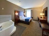 Guest room with 1 King bed, flat-screen TV, work desk and chair, and a whirlpool.