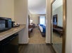 Guest room entrance, microwave, mini fridge, coffee maker, and 2 double beds.