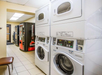Laundry area equipped with washers and dryers.