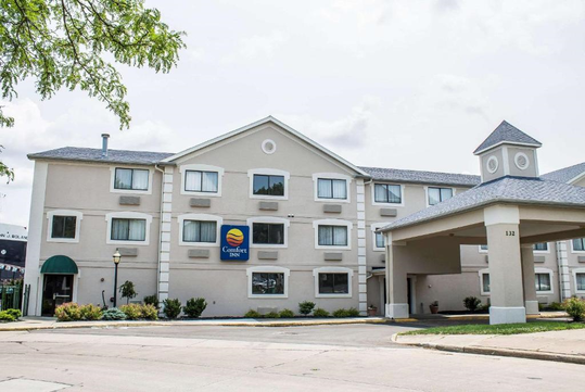 Exterior view of a three-story Comfort Inn hotel with a covered entrance and several windows.