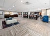 Beautifully decorated common area with a sofa and flat-screen TV.