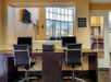 Business center with comfortable chairs and computers.