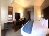 A hotel room with a king bed, flat-screen TV, and a seating area in at the Comfort Inn & Suites Ukiah.