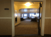 A hotel room entrance with a bed and desk in the room at the Comfort Inn & Suites Ukiah Mendocino County.