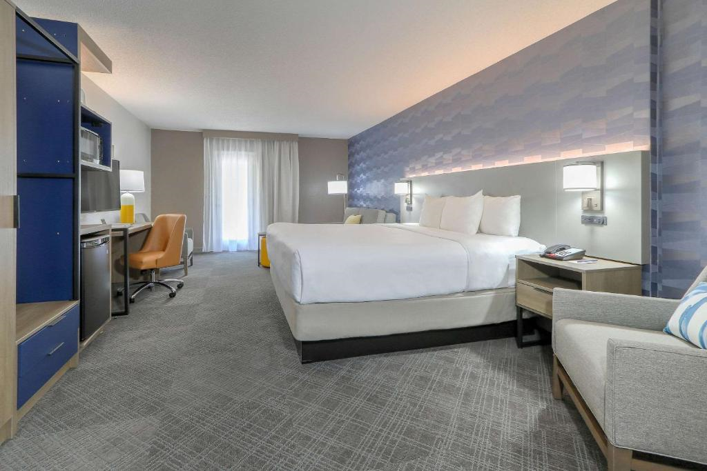 The room offers a king bed, a work desk, and a TV for a comfortable and productive stay.