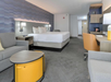 Relax in a room featuring a king bed, work desk, and cozy seating area.