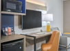 This space features a TV, work desk, microwave, and mini-fridge to enhance your stay.