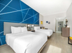 Relax in a room featuring two queen beds and a sofa bed for extra comfort.