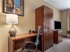 Working area, closet, and a flat-screen TV inside a guest room at Comfort Suites Mason Near Kings Island.