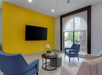 Beautifully decorated common area with a sofa and flat-screen TV.